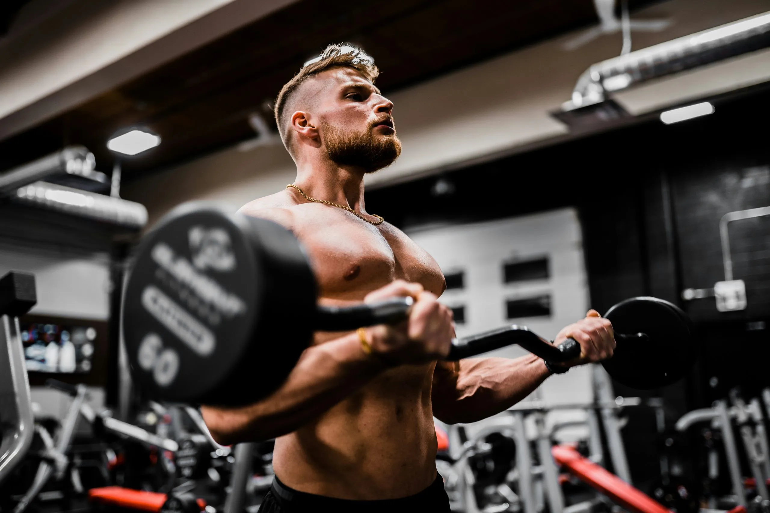Athlete lifting a heavy dumbbell in a gym