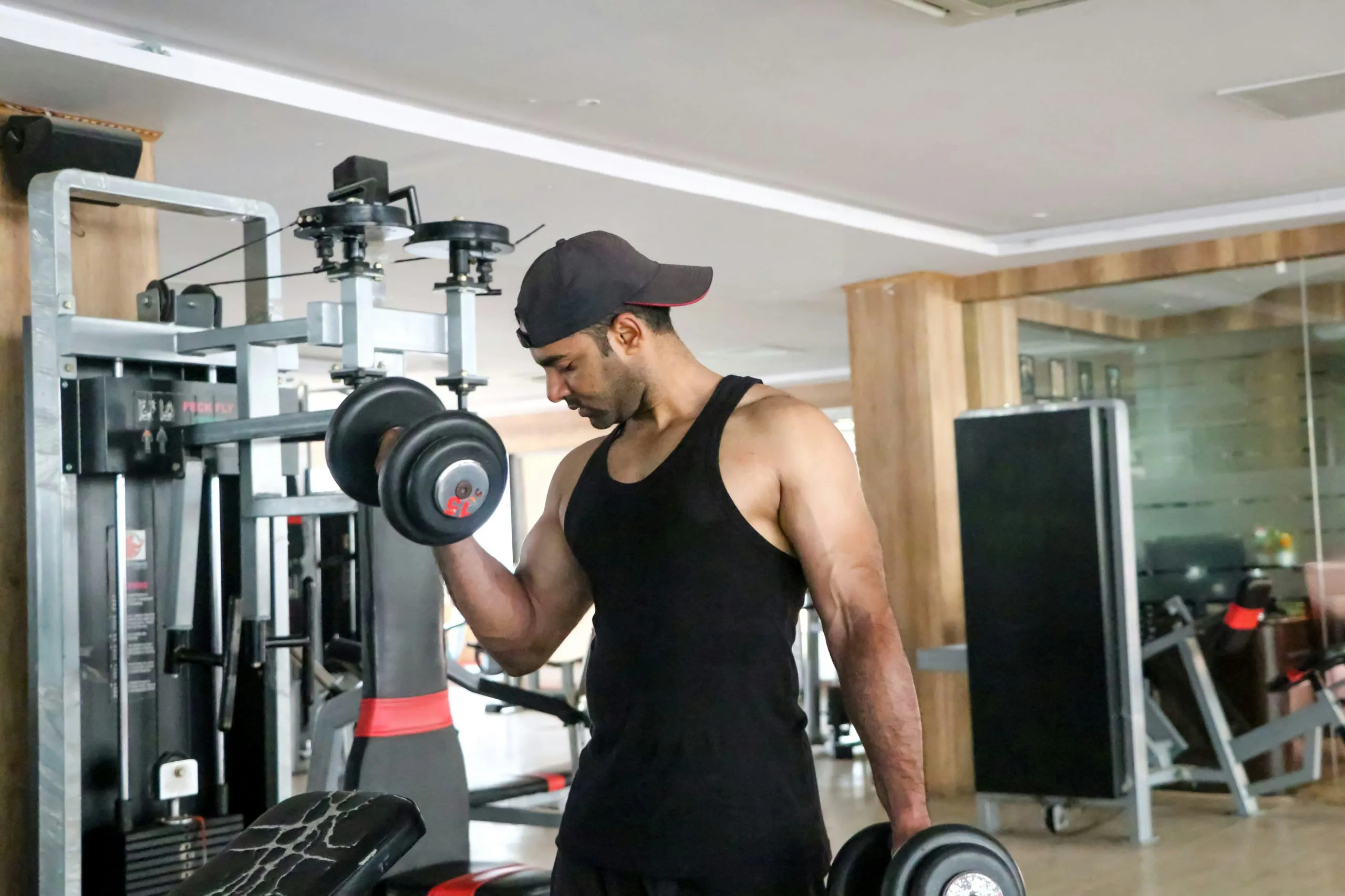 Athlete curling a dumbbell in a gym